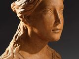 a close up of a statue of a woman with long hair