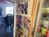 a glass display case with magazines on it in the hallway