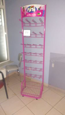 a pink shelf with a lot of items on it