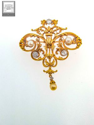 an image of a gold brooch with a pearl and diamond pendant