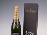 une bouteille de champagne Moët & Brandon à côté d'une boîte