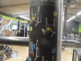 a pole with a sticker on it in a gym