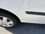 a close up of a car ' s tire on the pavement