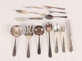 a lot of silver spoons and forks on the table