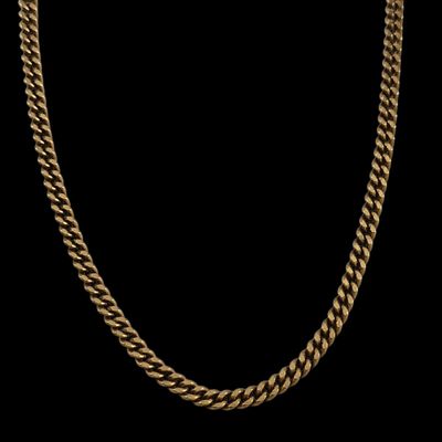 un collier à chaîne en or avec un maillon plat sur fond noir