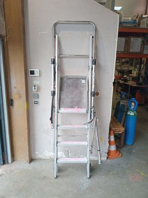 a ladder that is leaning against a wall in a garage