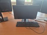 a computer desk with two monitors and a keyboard on it