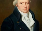 portrait d'un homme vêtu d'un manteau bleu et d'une chemise blanche