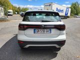 the rear end of a white volkswagen suv parked in a parking lot