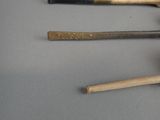 three baseball bats and a ball on a table