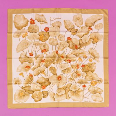a close up of a square scarf with flowers on it