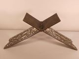 a close up of a metal object on a white surface