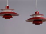 two red and white lamps hanging from the ceiling