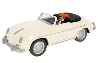 a white toy car with a black and orange cat in it