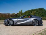 the silver sports car is parked in the parking lot