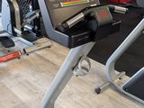 a gym room with a tread machine and other equipment