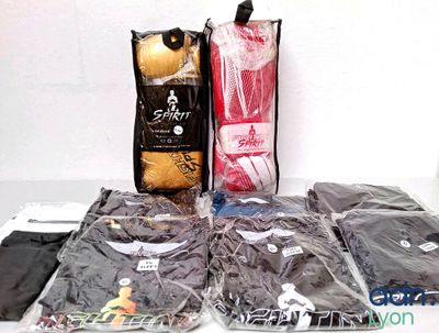 many bags of clothing sitting on a table next to each other