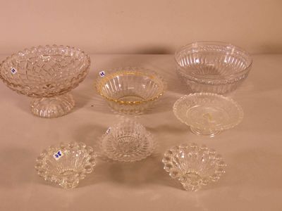 several glass bowls and bowls on a table with a white background