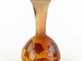 a glass vase with a brown and yellow design on it