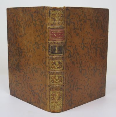 the front cover of a book with a gold and red cover