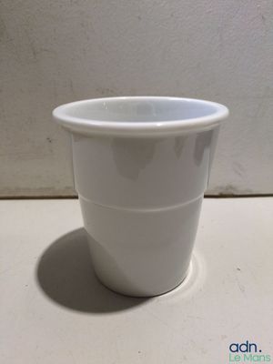 a white cup that is sitting on a table