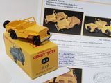 a yellow toy truck sitting on top of a box