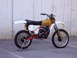 a dirt bike that is parked in a parking lot