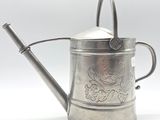 a silver watering can with a handle on a white background