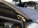 a car with its hood open and the engine in the back