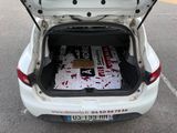 a trunk of a white car with a bunch of papers in it