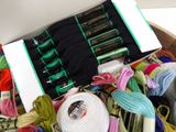 a box of yarn and a pair of scissors in it