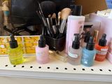 a lot of makeup products sitting on a shelf