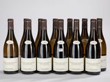 six bottles of wine are lined up in a row on a table