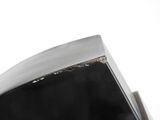 a close up of a black object on a white surface