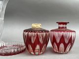 three glass vases sitting next to each other on a table