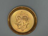une image représentant une pièce d'or sur laquelle figure un monogramme