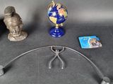 a globe, a pair of scissors, and a book on a table