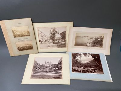quatre vieilles photographies en noir et blanc représentant des bâtiments et des arbres, posées sur une table