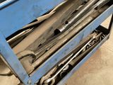 a lot of tools that are sitting in a blue cart