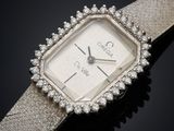 a close up of a wrist watch with a diamond bezel