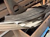 some pieces of wood are sitting on a pallet in a warehouse
