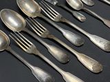 a lot of silver spoons and spoons on a table