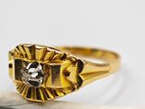 an image of a gold ring with a diamond in the center