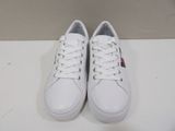 white leather sneakers with red and blue patches on the soles