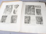an open book on a table with pictures of architectural details