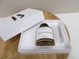 a bottle of perfume sitting in a box on a table