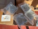 four pieces of plastic sitting on top of a cardboard box