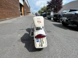 a motor scooter parked on the side of the road
