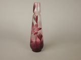 a glass vase with a pink flower inside of it