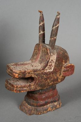 an image of a wooden sculpture of a dog ' s head with two horns